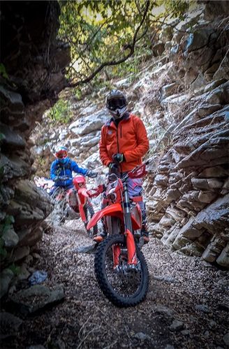 Rider standing on his bike